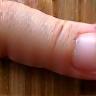 Hand touching solid wood surface